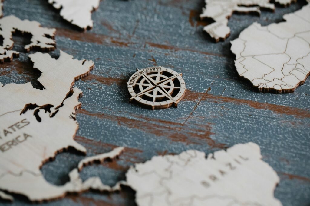 Close-up of a wooden world map featuring a detailed compass rose design.